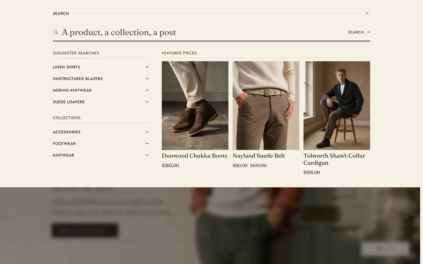 The Lapels search drawer dropped from the top of the page over a dimmed home page: a wide empty search field, then Suggested searches and a Collections list down the left, and three Featured pieces shown as picture cards with their names and prices across the right.